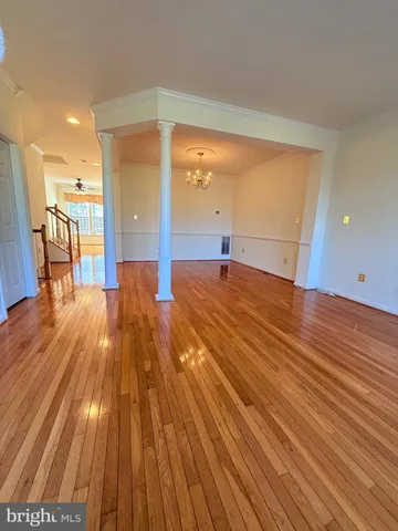a view of a room with wooden floor