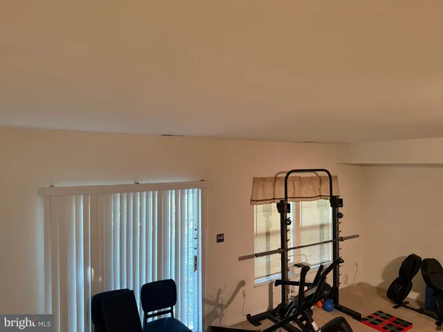 a view of a livingroom with furniture and natural light