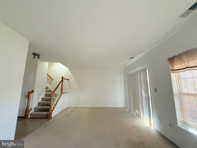 a balcony with wooden floor and outdoor seating