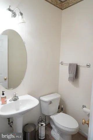 a bathroom with a sink a toilet and mirror