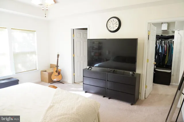 a bedroom with a bed and a television