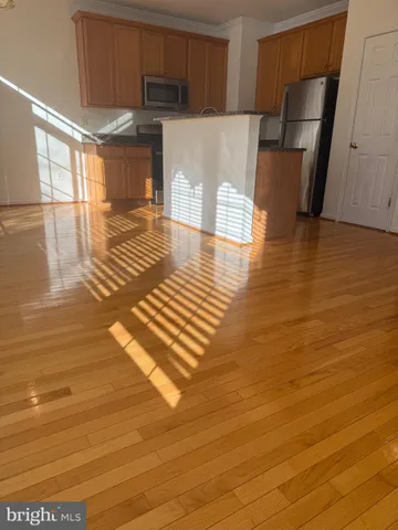 a view of a kitchen with wooden floor and a sink