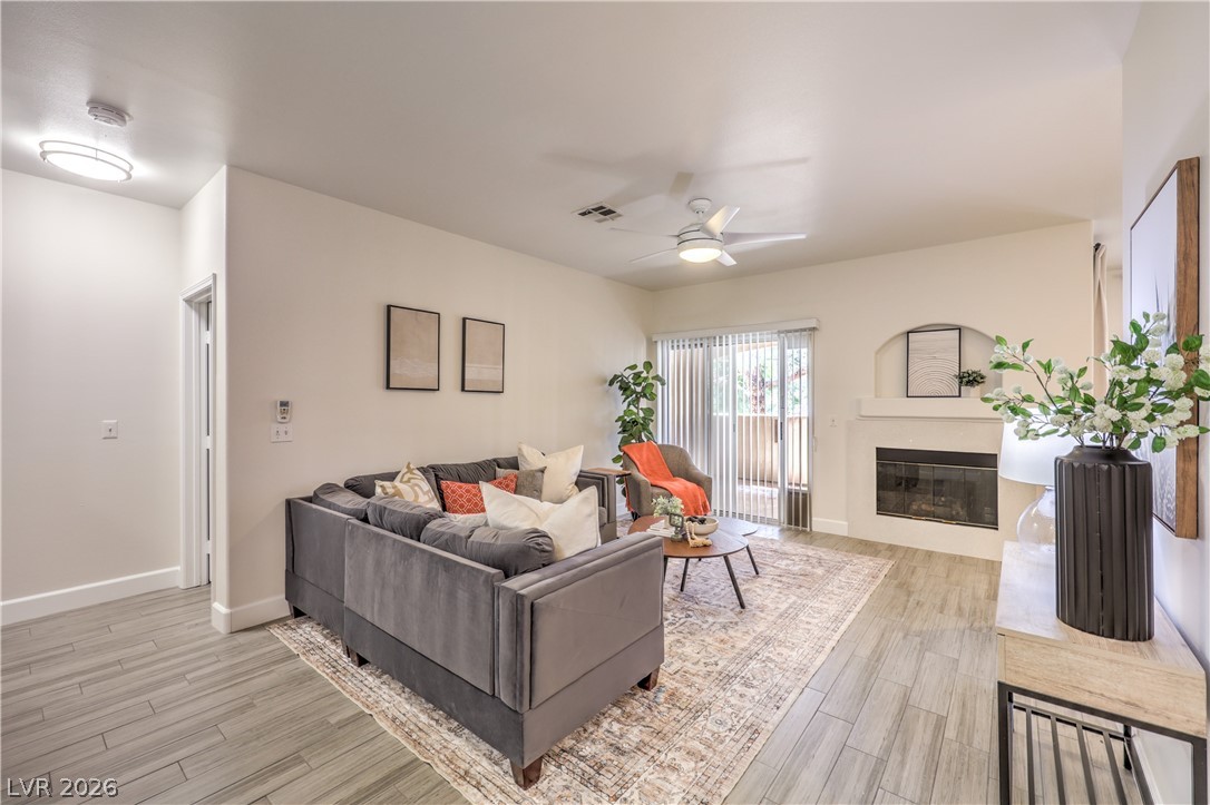 2050 West Warm Springs Road, Unit 1421 Henderson, NV 89014 - Photo 11 of 45 Relax in the cozy living area with a fireplace, ideal for unwinding after a long day.