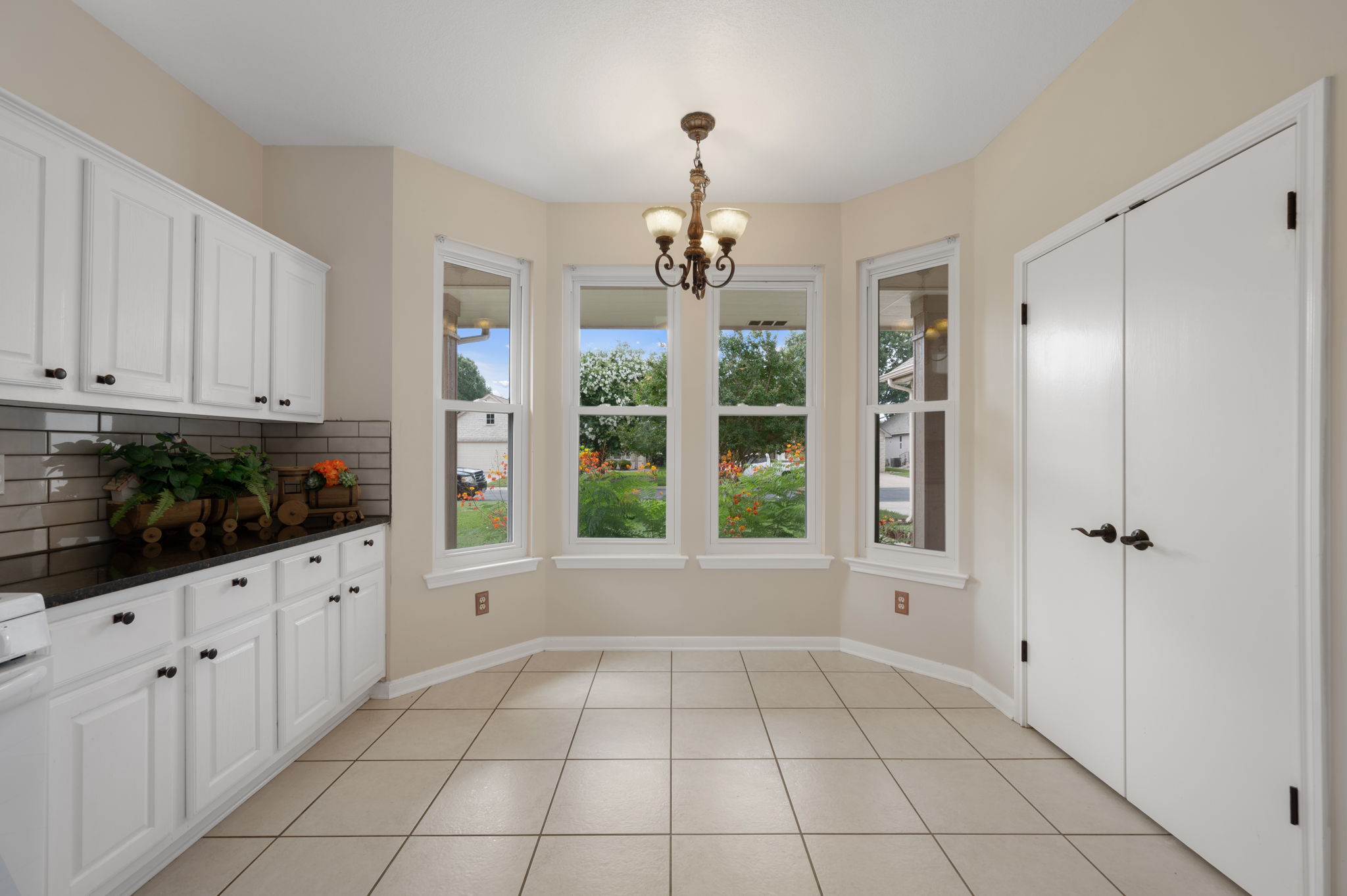 118 Bass Street Georgetown, TX 78633 - Photo 19 of 40 A well-lit breakfast area offers ample storage and a bay window overlooking a verdant outdoor space.