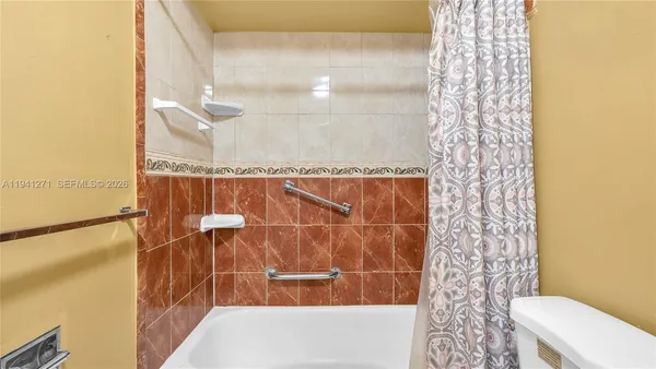 a bathroom with a shower curtain and a sink