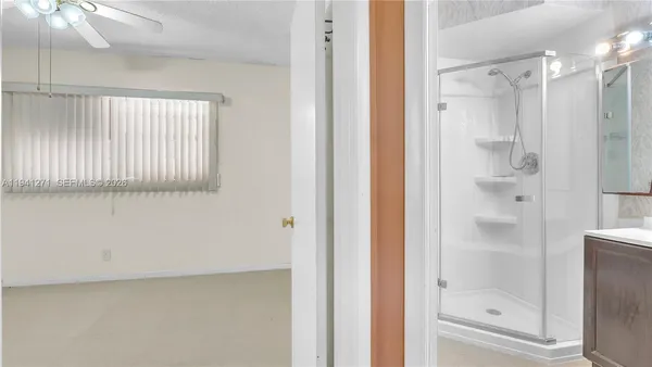 a bathroom with a glass shower door