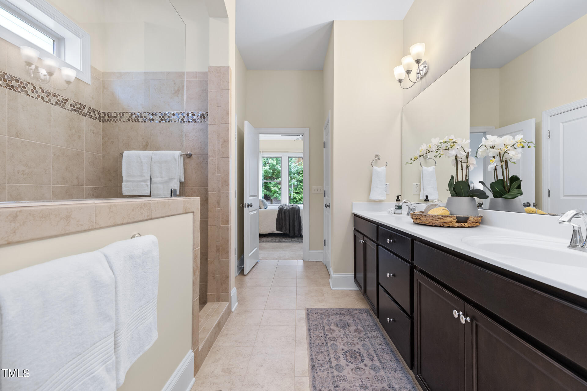 204 Mill Chapel Road Chapel Hill, NC 27517 - Photo 26 of 38 a en suite bathroom with a double vanity sink a mirror and a shower