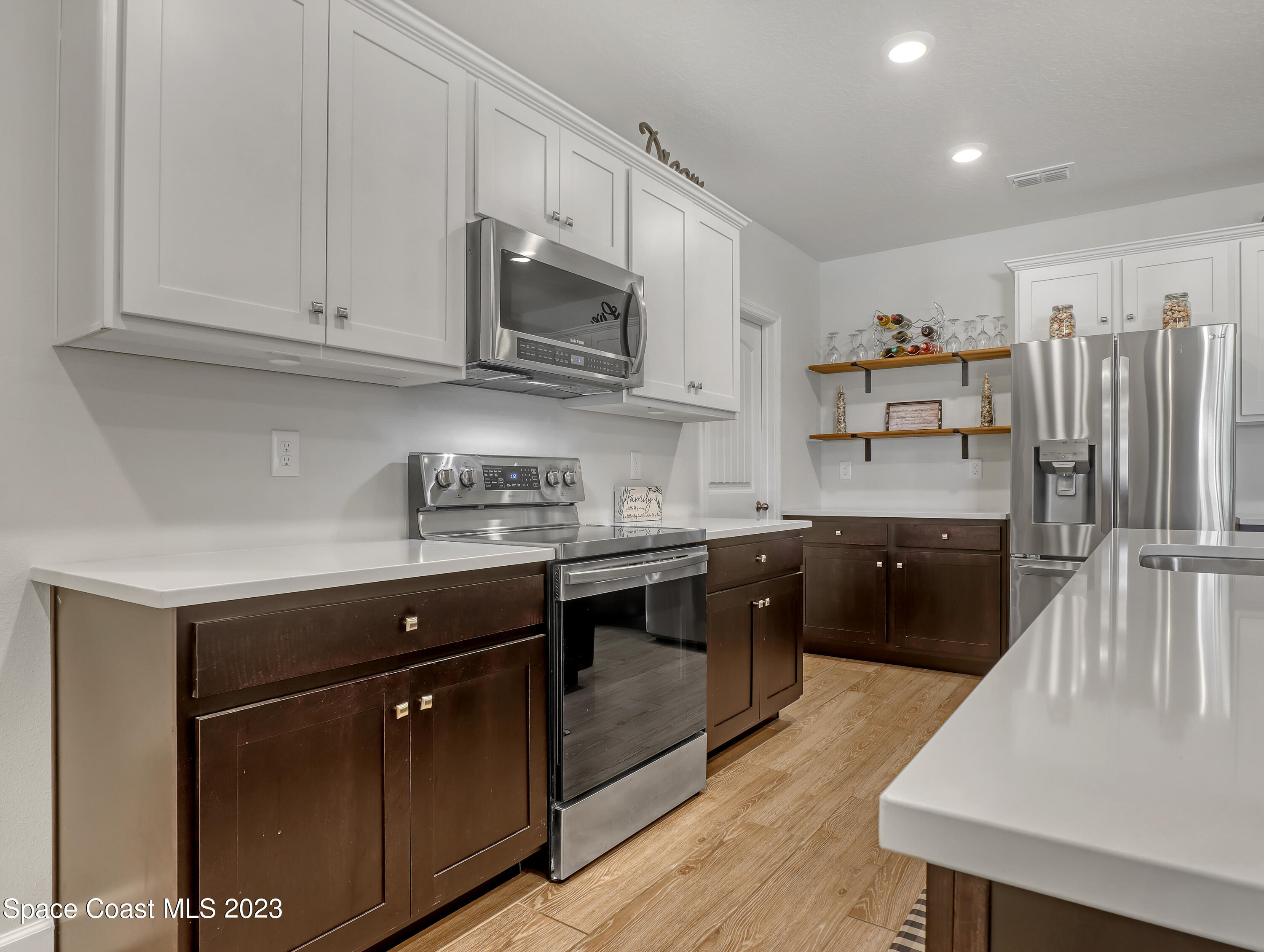 1807 Elkins Point Melbourne, FL 32935 - Photo 11 of 52 a kitchen with stainless steel appliances granite countertop a sink a stove and cabinets