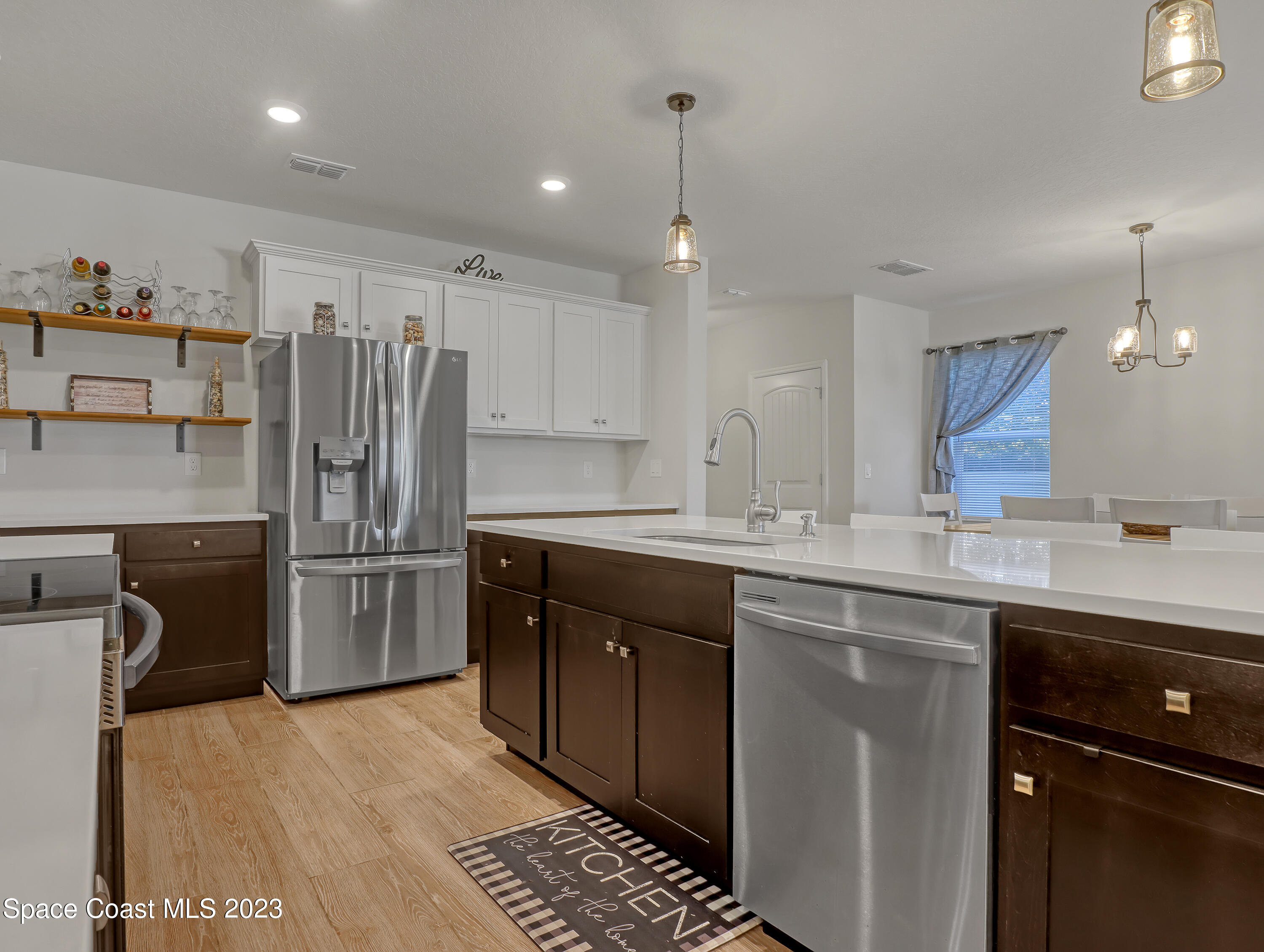 1807 Elkins Point Melbourne, FL 32935 - Photo 13 of 52 a kitchen with a sink a refrigerator and cabinets