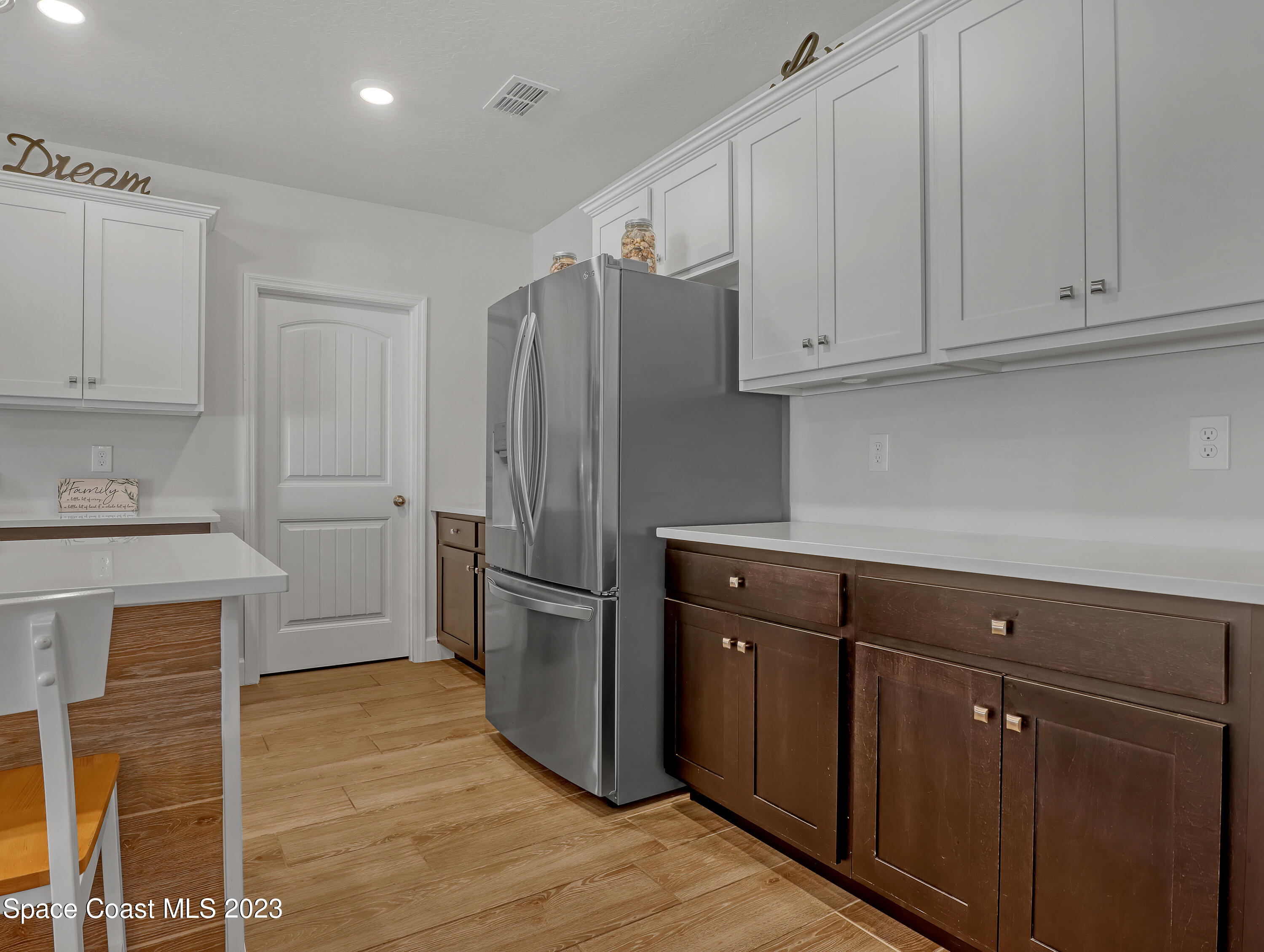 1807 Elkins Point Melbourne, FL 32935 - Photo 16 of 52 a kitchen with cabinets and stainless steel appliances