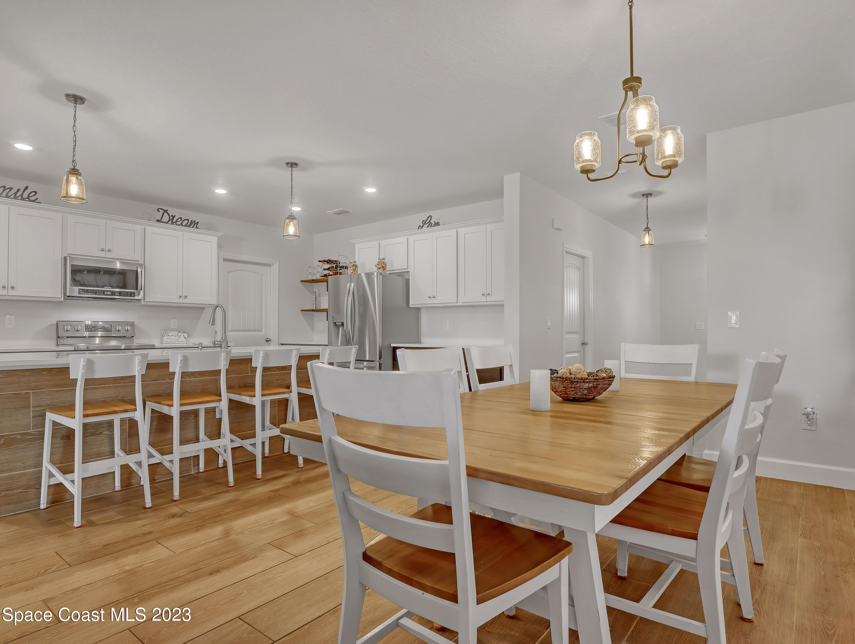 1807 Elkins Point Melbourne, FL 32935 - Photo 17 of 52 a view of a dining room with furniture and wooden floor