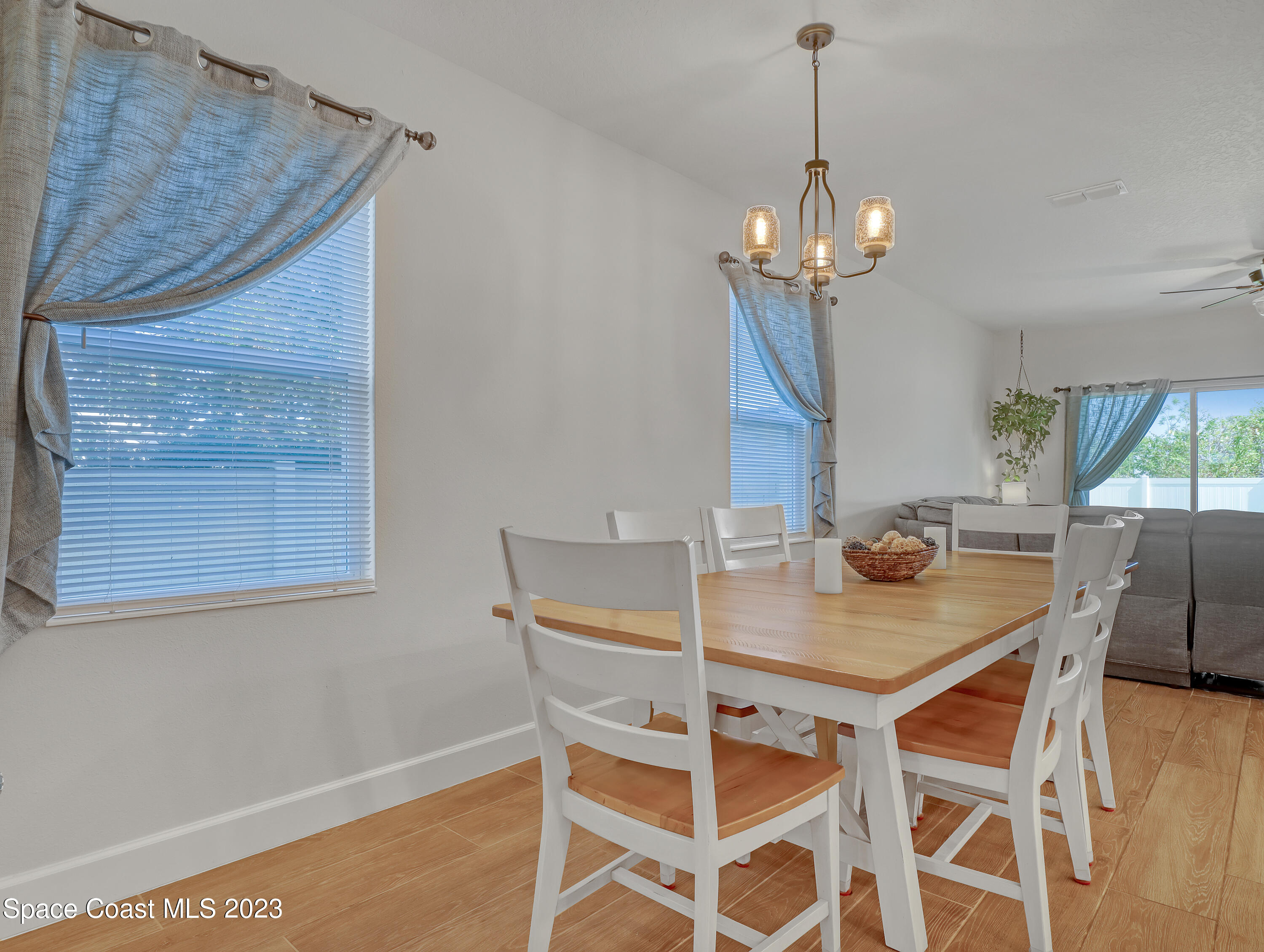 1807 Elkins Point Melbourne, FL 32935 - Photo 18 of 52 a view of a dining room with furniture and a chandelier