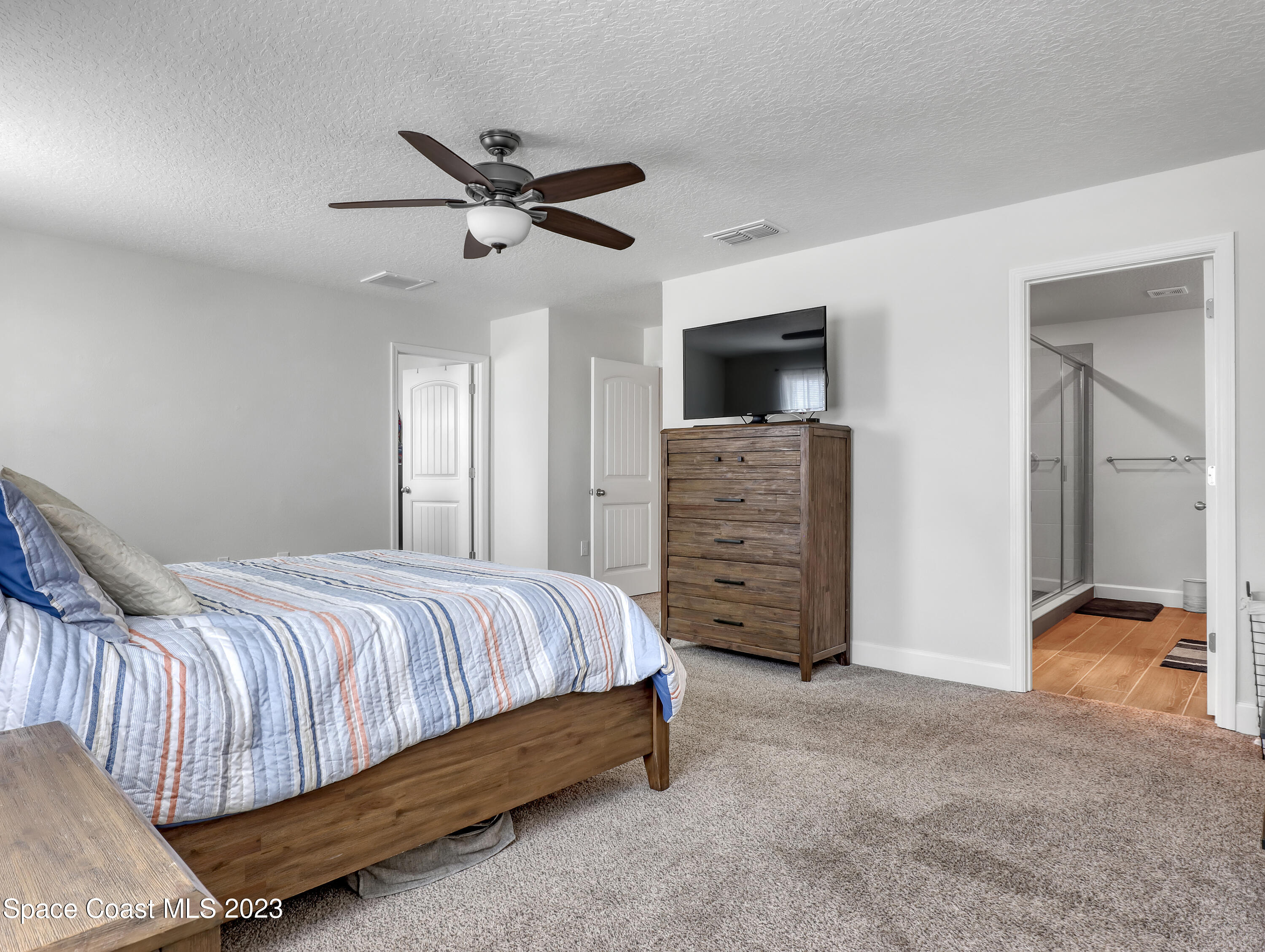 1807 Elkins Point Melbourne, FL 32935 - Photo 23 of 52 a bedroom with a bed and a television