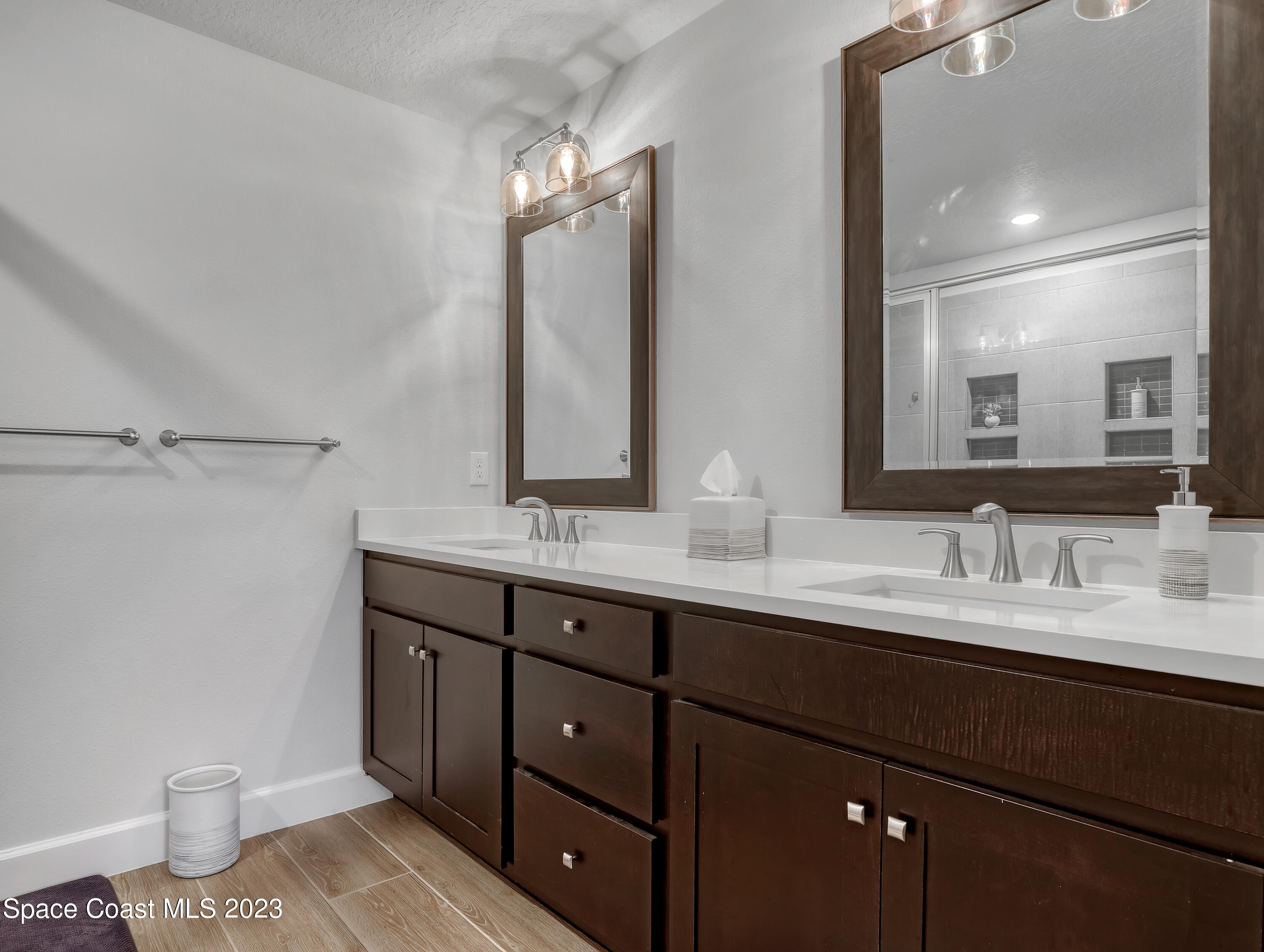 1807 Elkins Point Melbourne, FL 32935 - Photo 24 of 52 a bathroom with a double vanity sink and a mirror