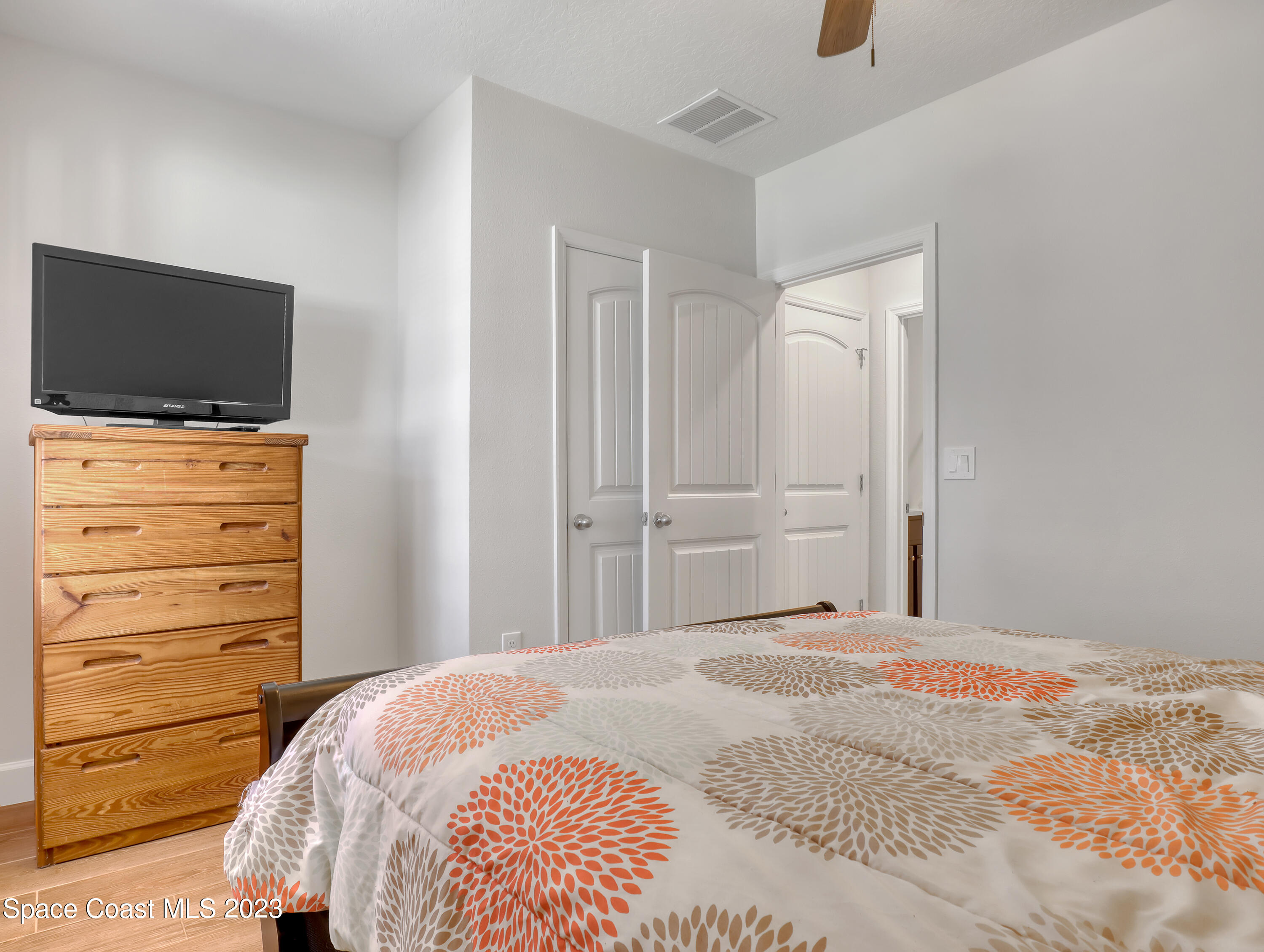 1807 Elkins Point Melbourne, FL 32935 - Photo 29 of 52 a bedroom with a bed and flat screen tv