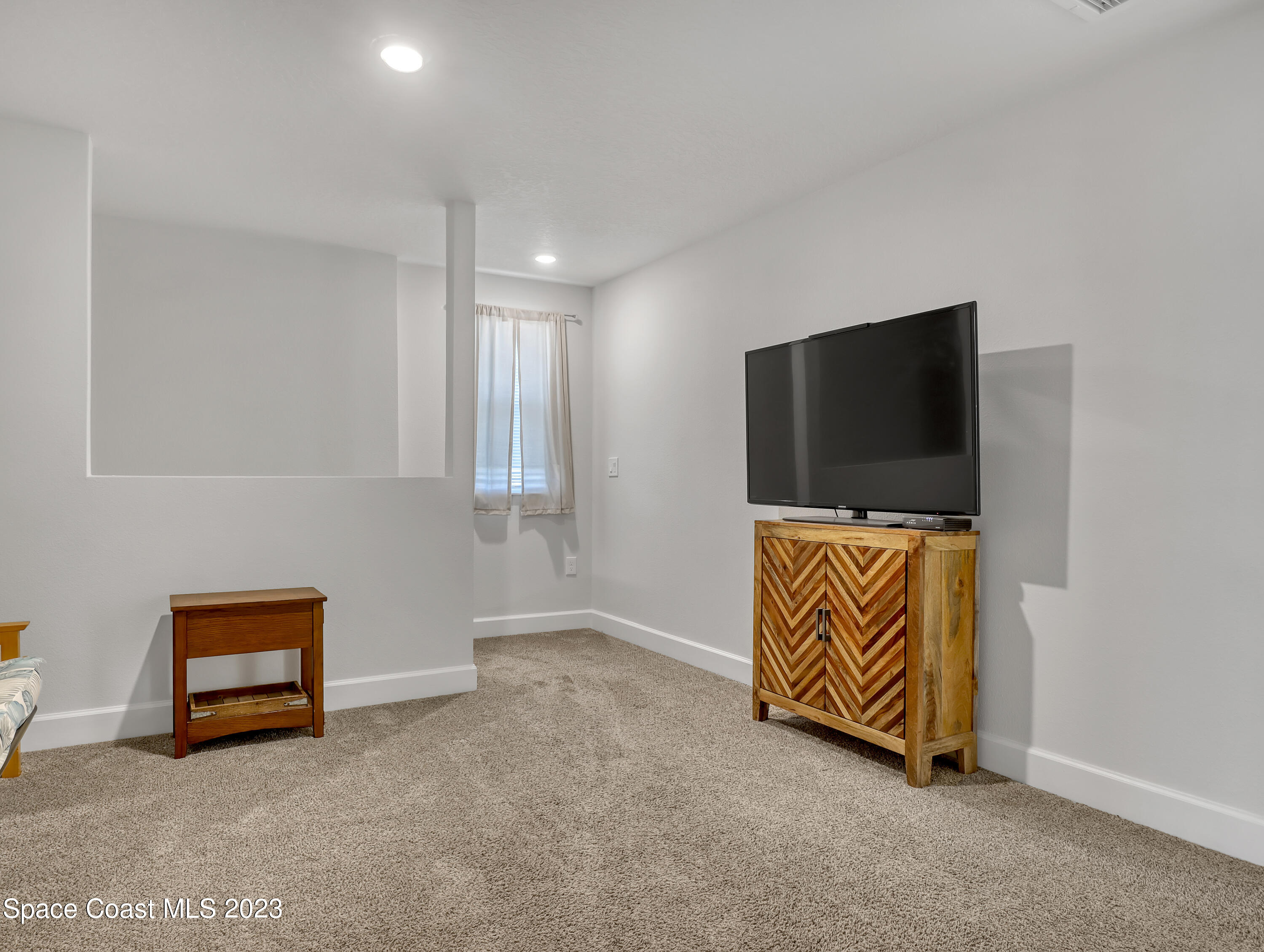 1807 Elkins Point Melbourne, FL 32935 - Photo 30 of 52 a room with furniture and a flat screen tv