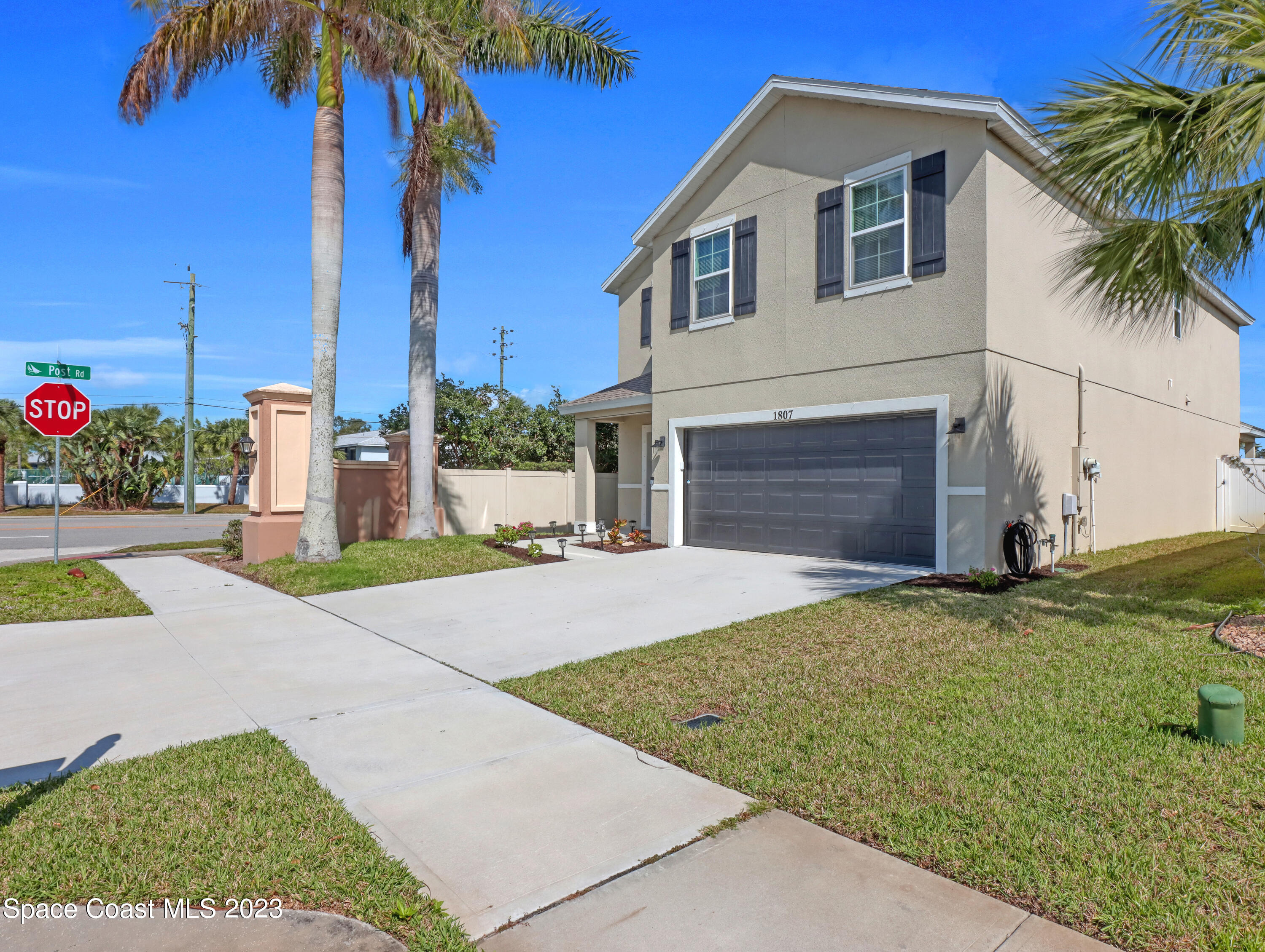 1807 Elkins Point Melbourne, FL 32935 - Photo 3 of 52 a front view of a house with a yard and garage