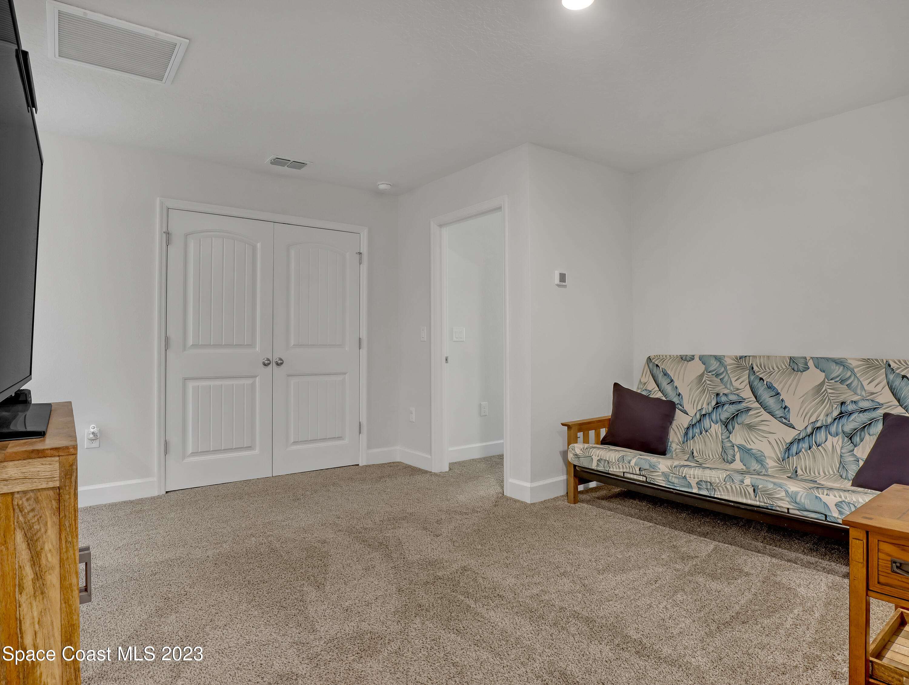 1807 Elkins Point Melbourne, FL 32935 - Photo 31 of 52 a living room with furniture and a flat screen tv