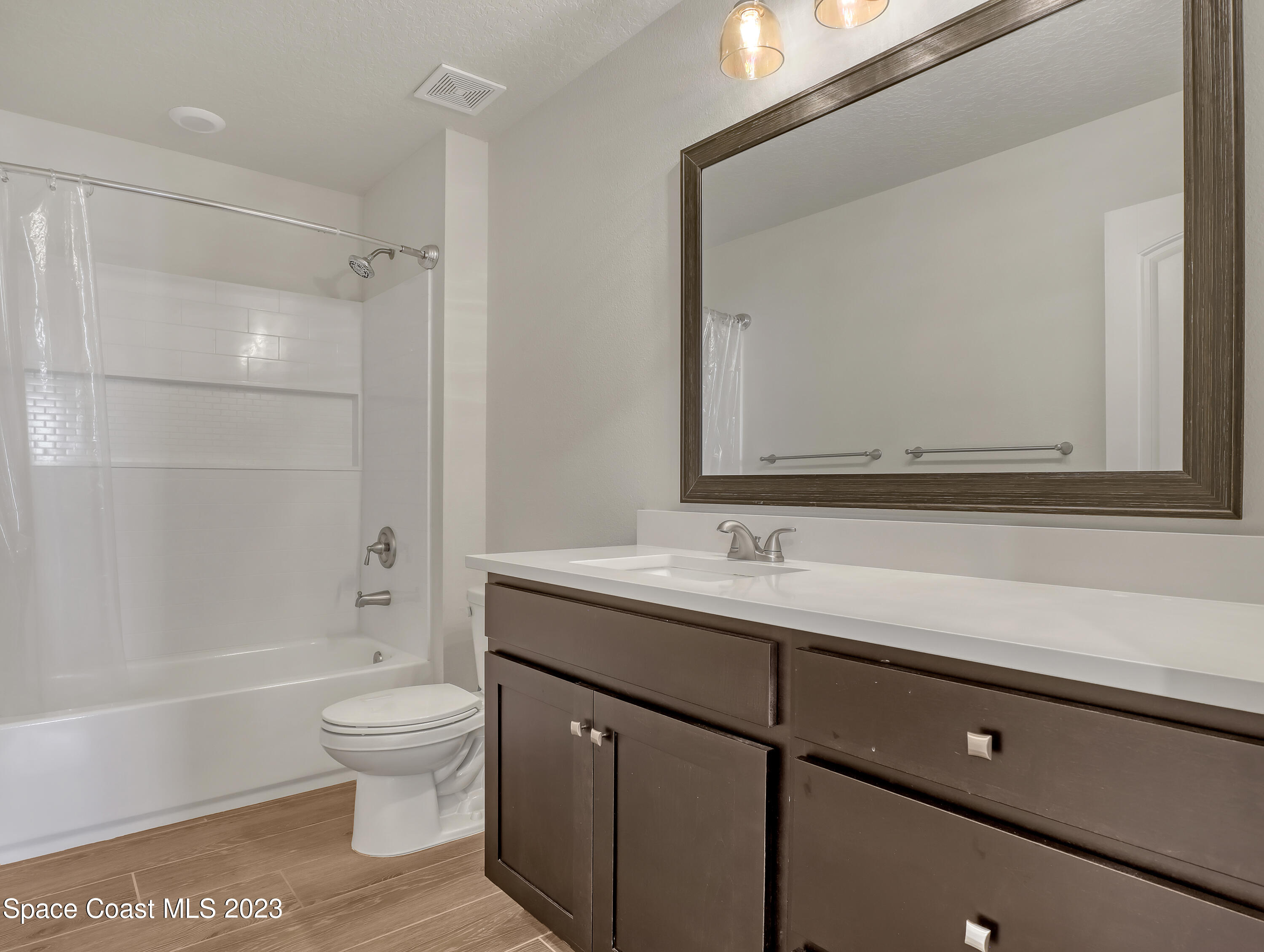 1807 Elkins Point Melbourne, FL 32935 - Photo 32 of 52 a bathroom with a sink a toilet and shower