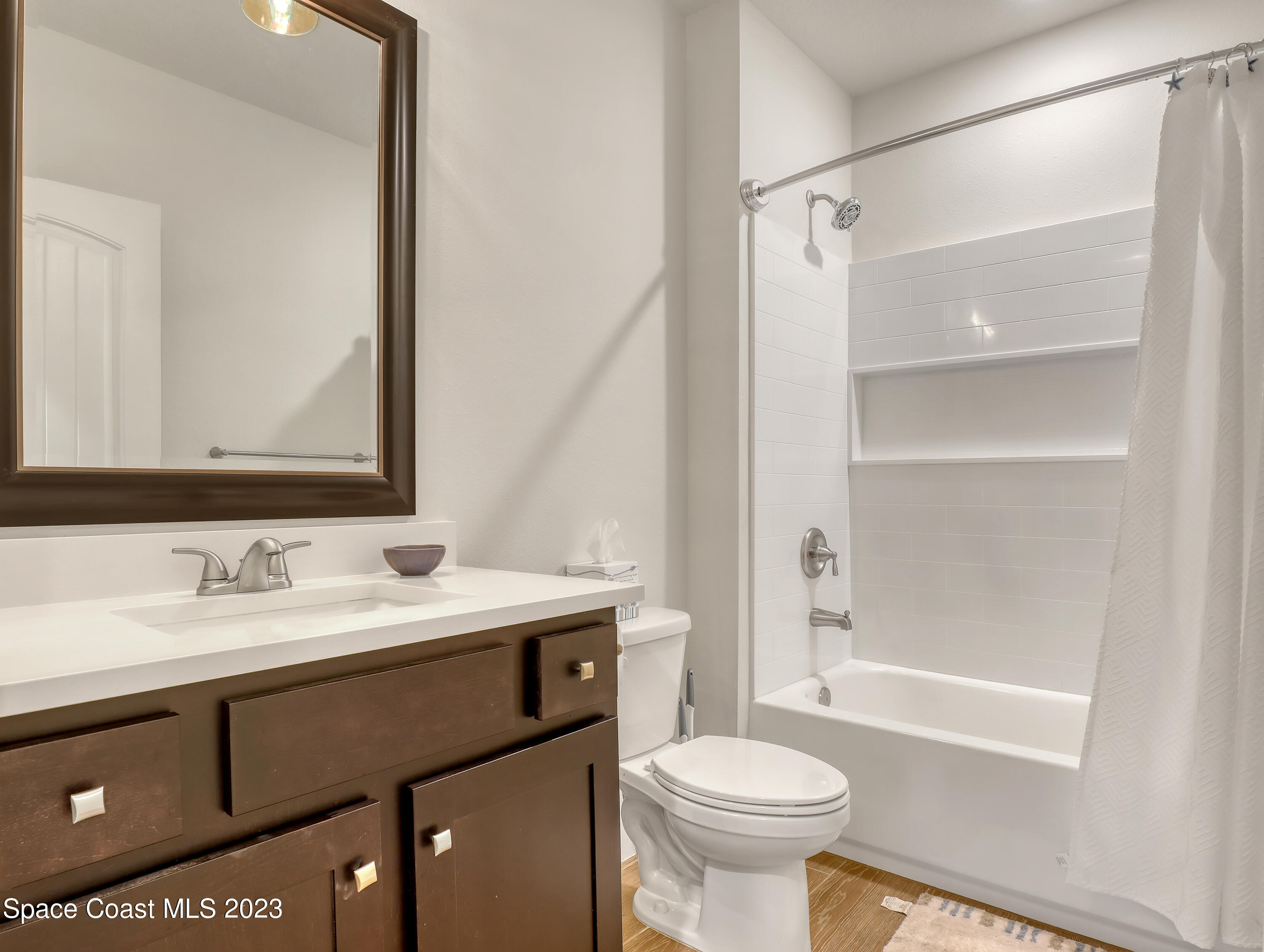 1807 Elkins Point Melbourne, FL 32935 - Photo 33 of 52 a bathroom with a sink a toilet and a mirror