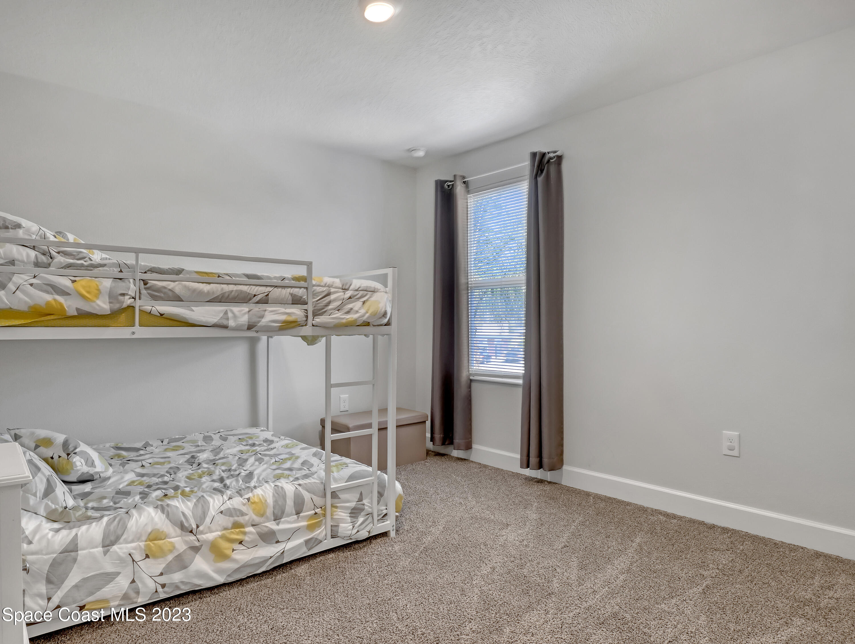 1807 Elkins Point Melbourne, FL 32935 - Photo 38 of 52 a bedroom with a bed and a table