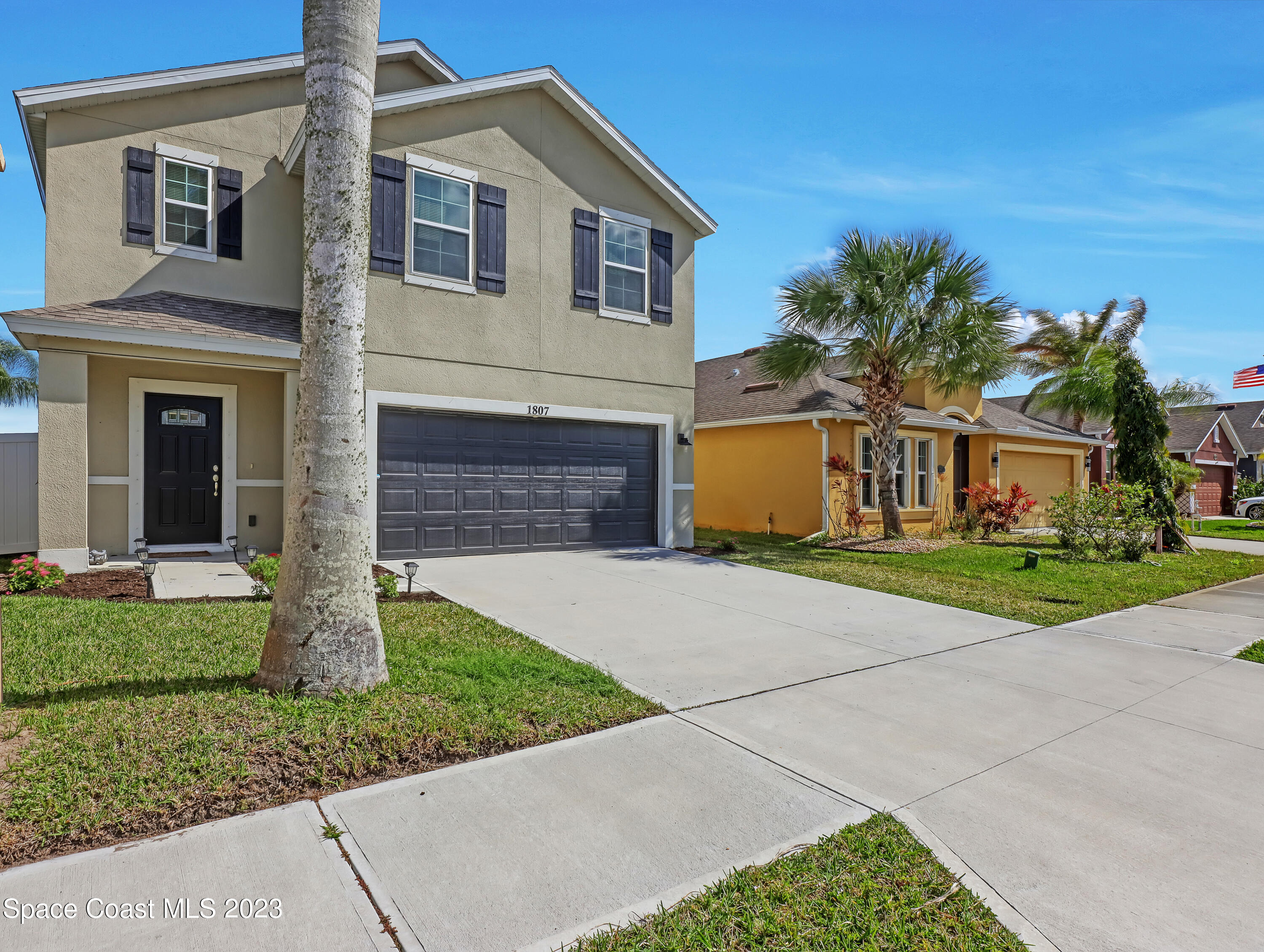 1807 Elkins Point Melbourne, FL 32935 - Photo 4 of 52 a front view of a house with a yard and garage
