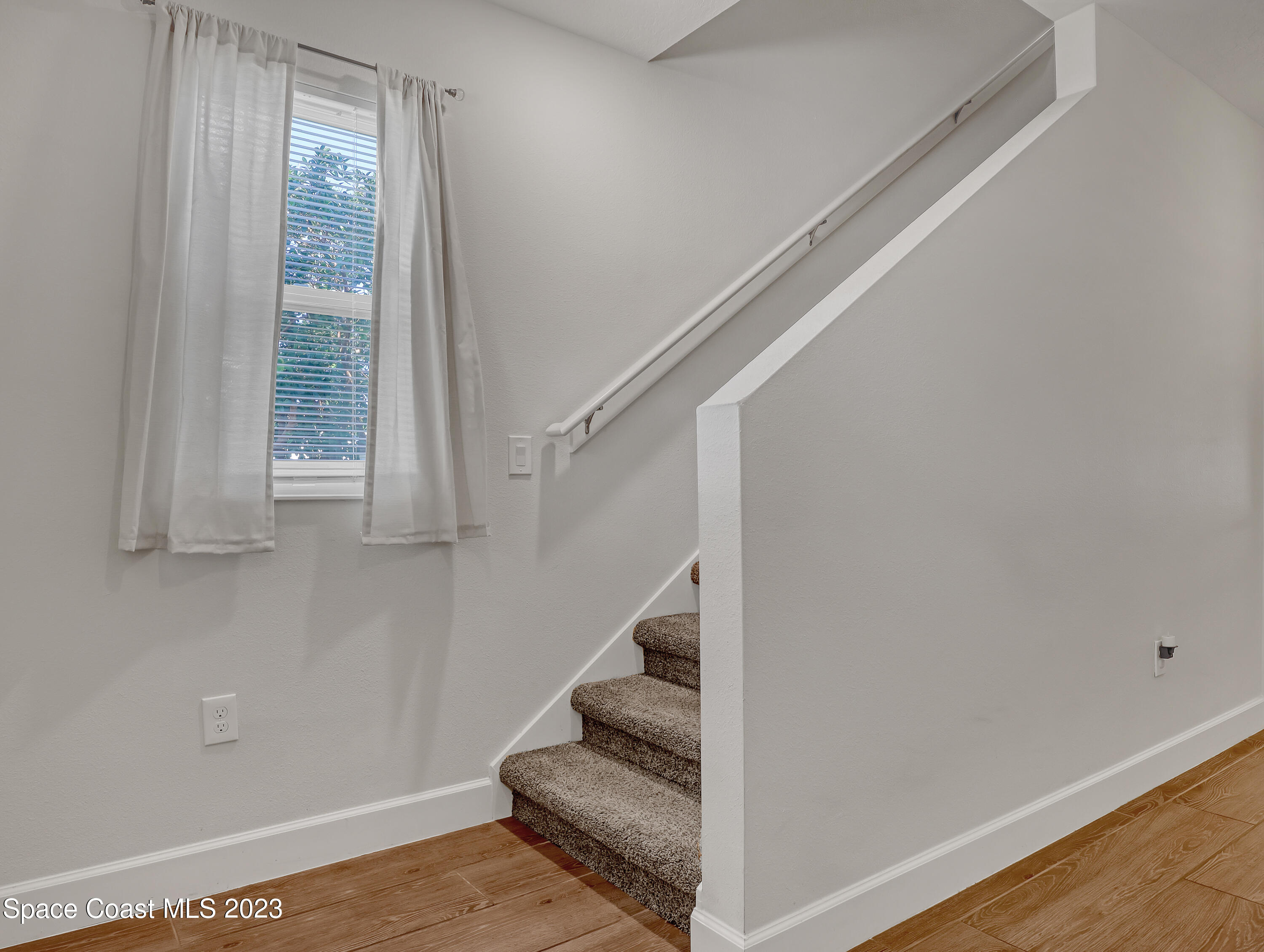 1807 Elkins Point Melbourne, FL 32935 - Photo 7 of 52 a view of entryway and hall with wooden floor