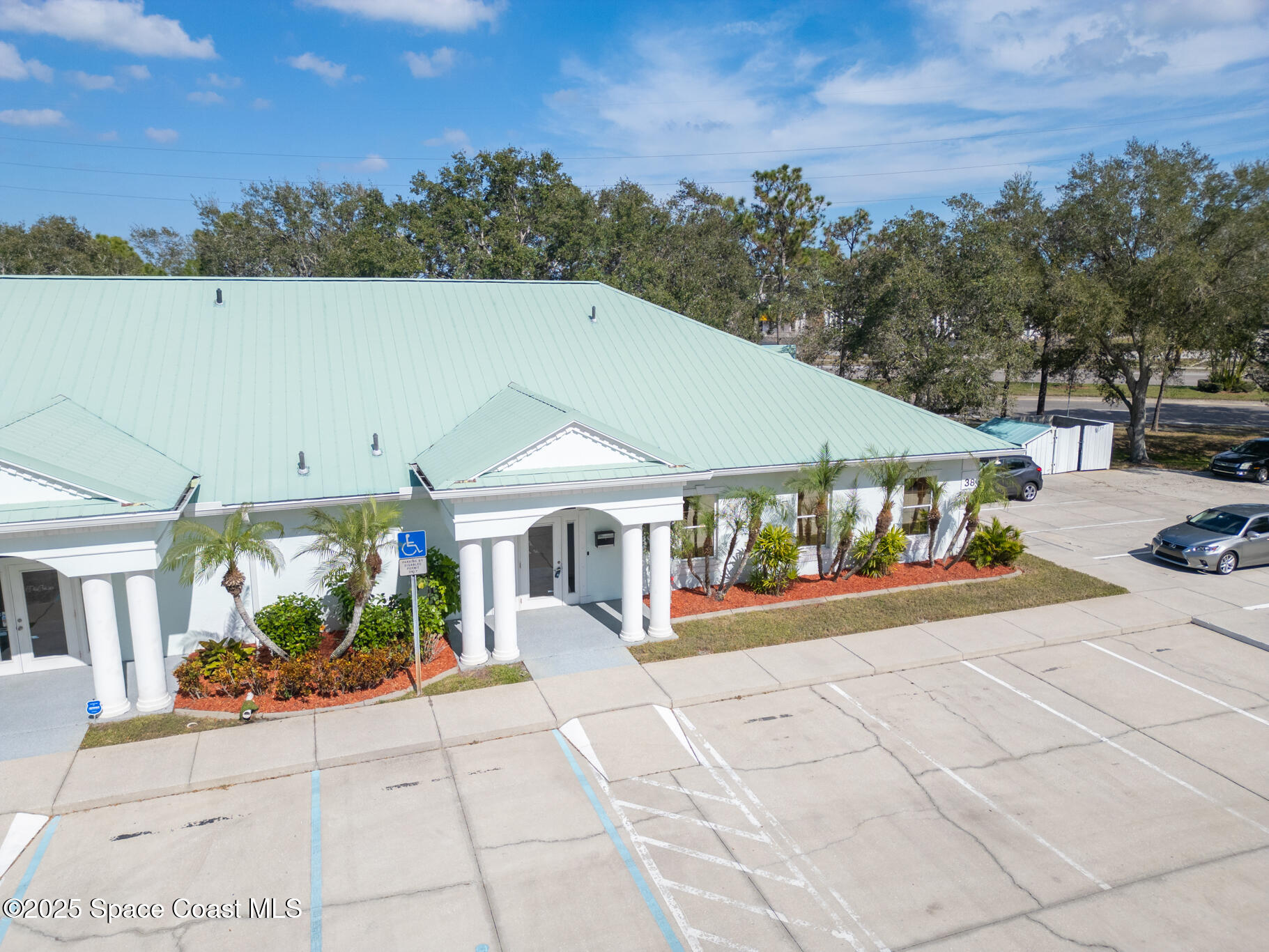 38 Suntree Place, Unit 2 Melbourne, FL 32940 - Photo 2 of 52 a view of a white house with a yard and potted plants