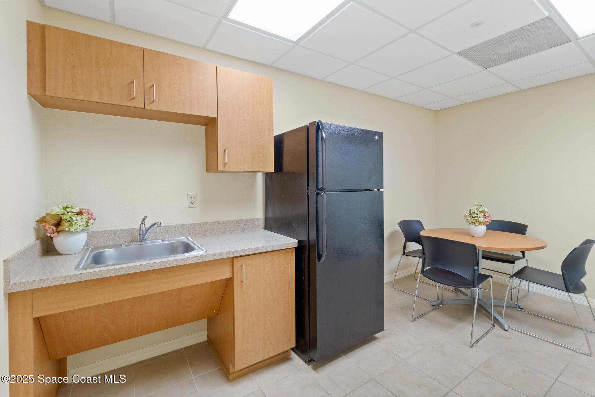 38 Suntree Place, Unit 2 Melbourne, FL 32940 - Photo 29 of 52 a kitchen with refrigerator and cabinets