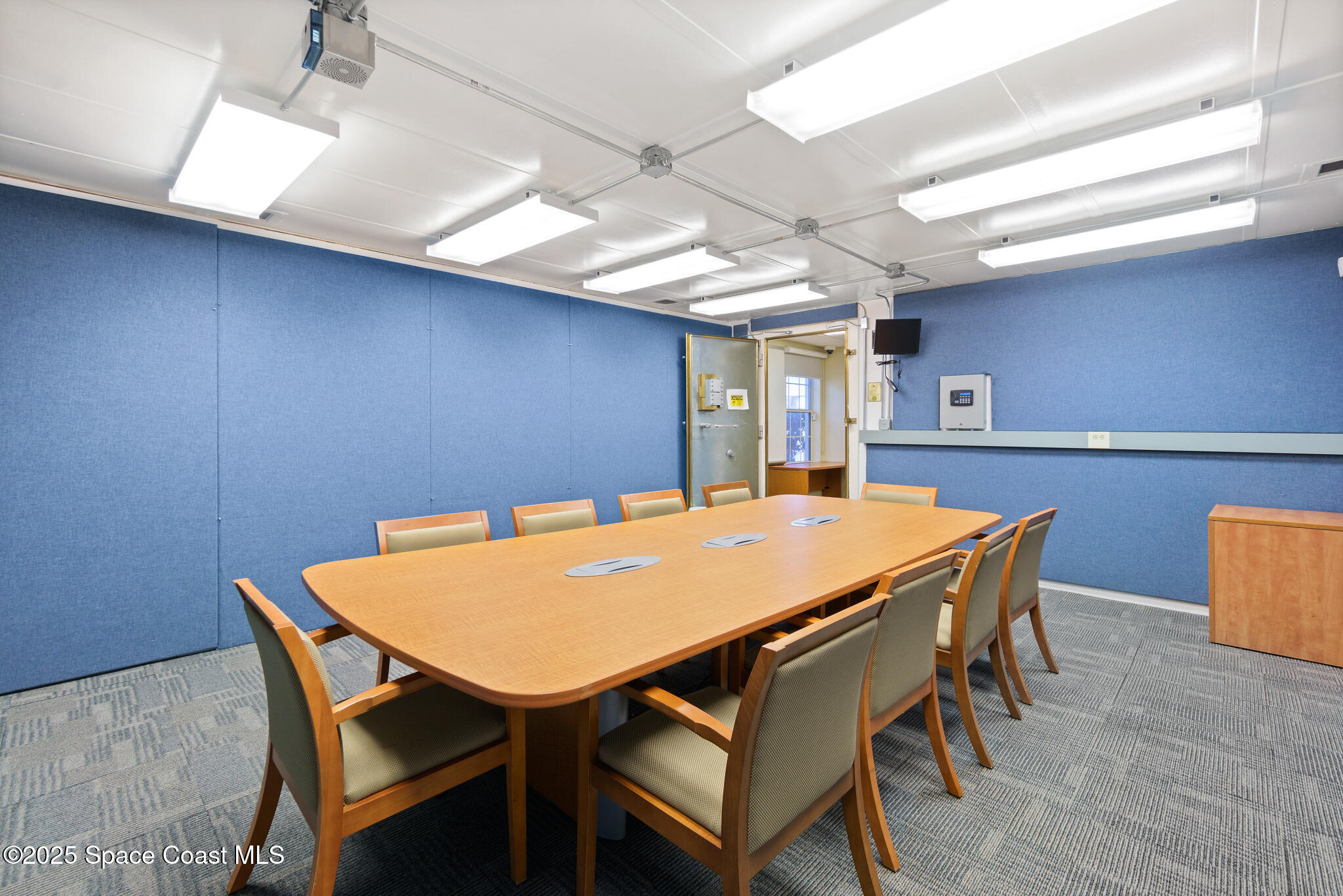 38 Suntree Place, Unit 2 Melbourne, FL 32940 - Photo 37 of 52 a dining room with a wooden table and chairs