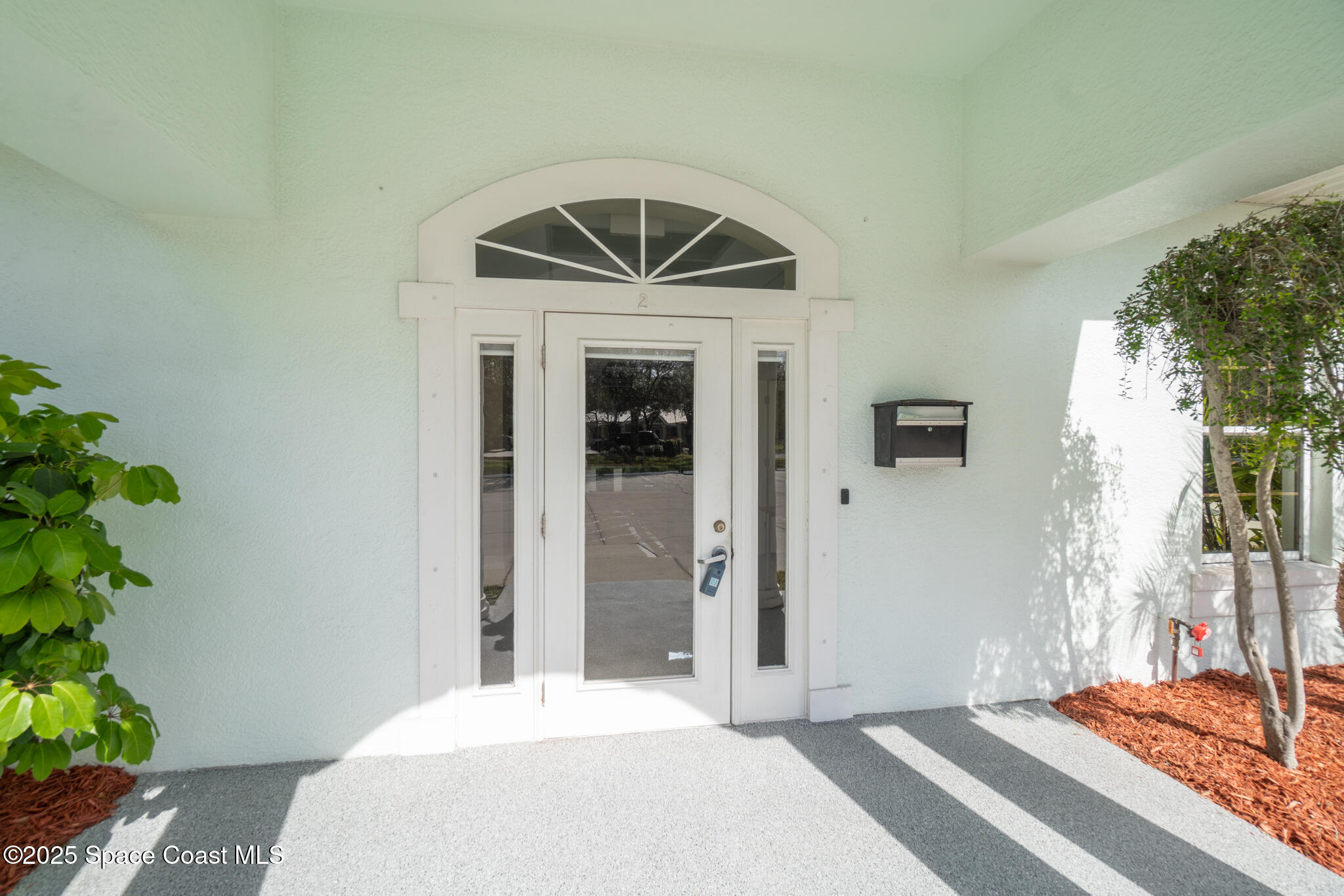 38 Suntree Place, Unit 2 Melbourne, FL 32940 - Photo 4 of 52 a bedroom with a bed and a potted plant