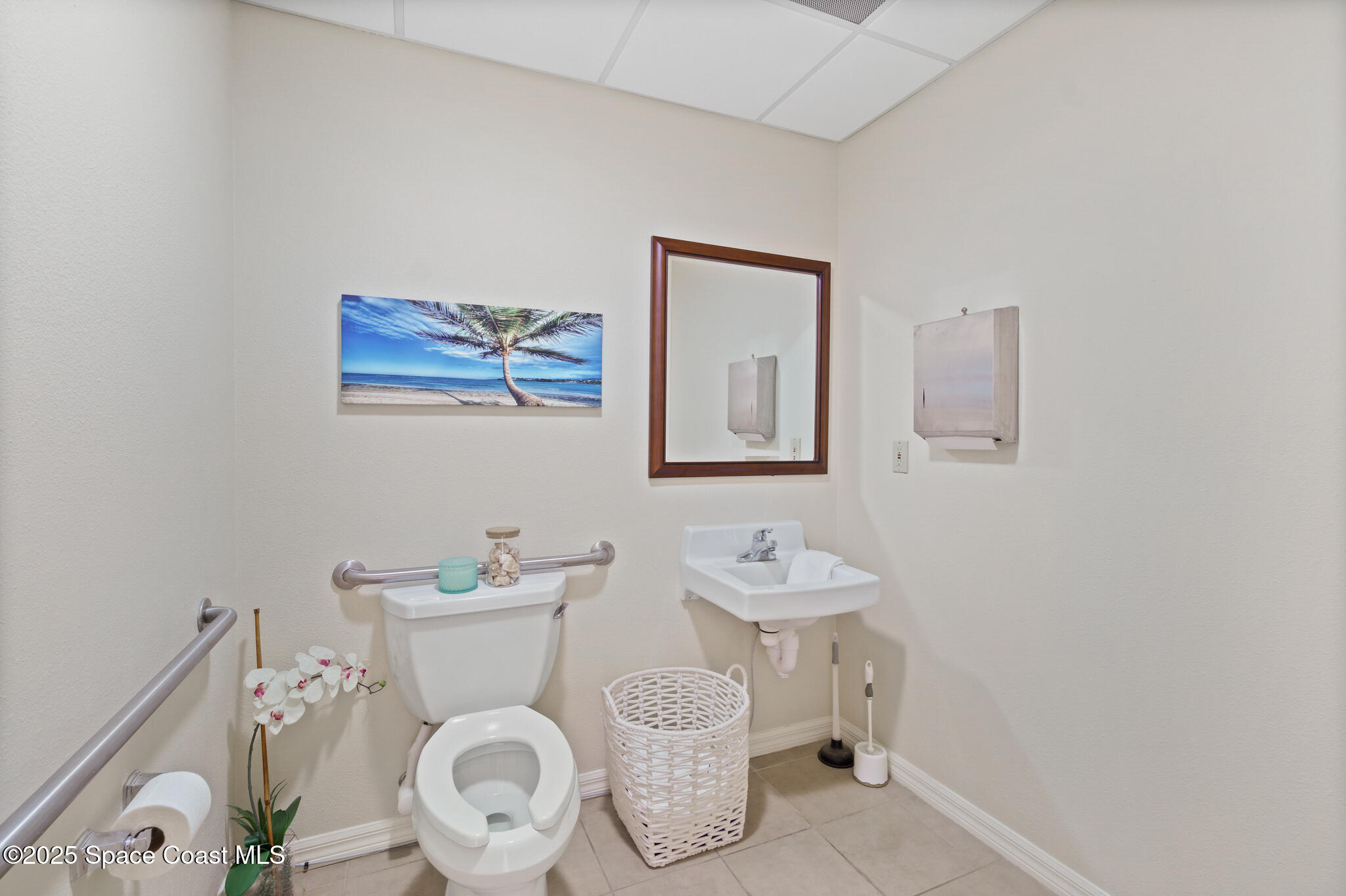 38 Suntree Place, Unit 2 Melbourne, FL 32940 - Photo 41 of 52 a bathroom with a toilet sink and mirror