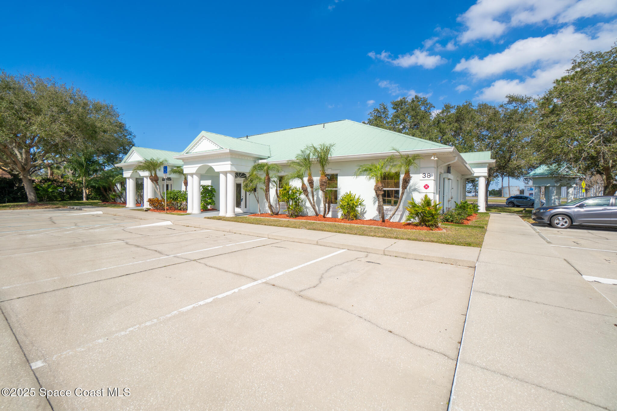 38 Suntree Place, Unit 2 Melbourne, FL 32940 - Photo 6 of 52 a front view of a building with a garden