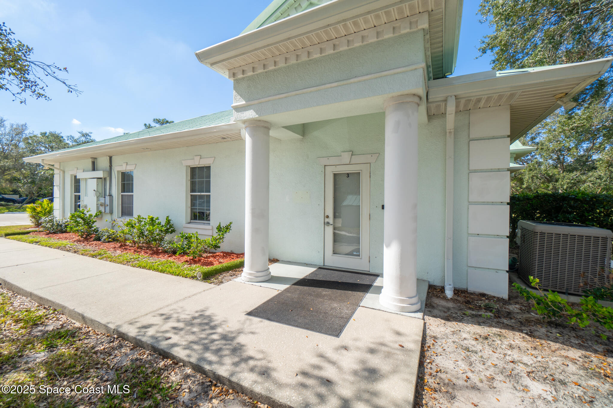 38 Suntree Place, Unit 2 Melbourne, FL 32940 - Photo 9 of 52 a front view of a house with a yard