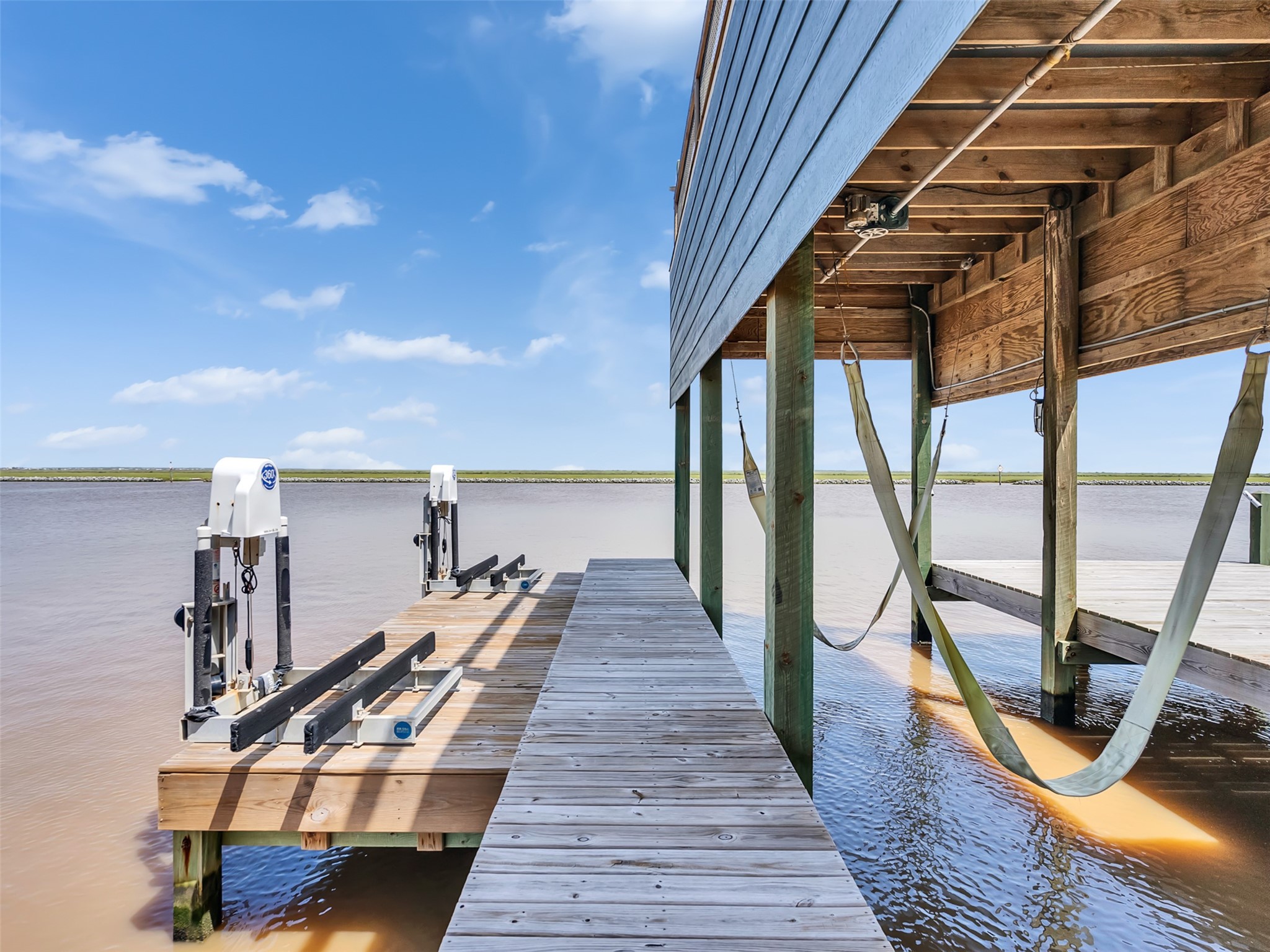 1453 County Road 230 Sargent, TX 77414 - Photo 28 of 38 Jet Ski Lifts — Enjoy easy access to the Intracoastal Waterway from this spacious deck featuring two Jet Ski lifts, making it the perfect setup for boating, fishing, watersports, and coastal adventures