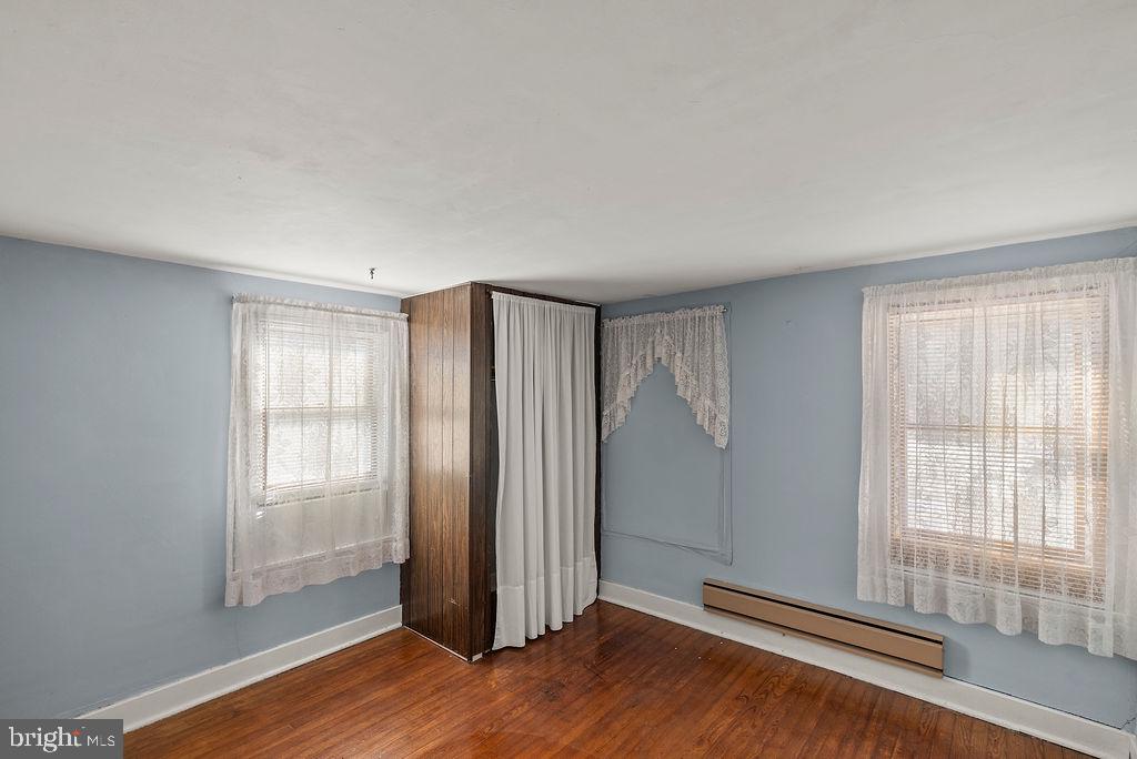 470 Racetrack Road Abbottstown, PA 17301 - Photo 30 of 54 an empty room with wooden floor and windows