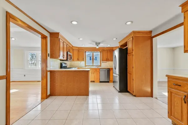 a view of kitchen with stainless steel appliances granite countertop a refrigerator and a sink