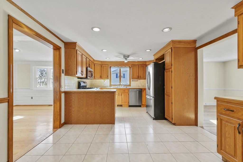 72 Cambridge Road, Unit 2 Woburn, MA 01801 - Photo 12 of 30 a view of kitchen with stainless steel appliances granite countertop a refrigerator and a sink