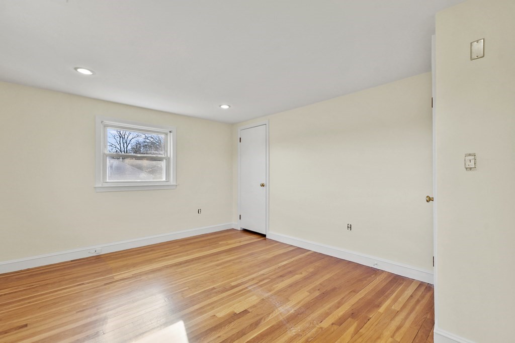 72 Cambridge Road, Unit 2 Woburn, MA 01801 - Photo 24 of 30 a view of a room with wooden floor and white walls