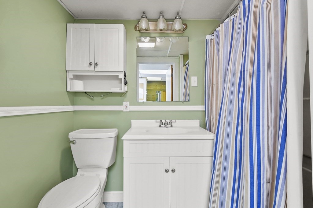72 Cambridge Road, Unit 2 Woburn, MA 01801 - Photo 26 of 30 a bathroom with a toilet sink and mirror
