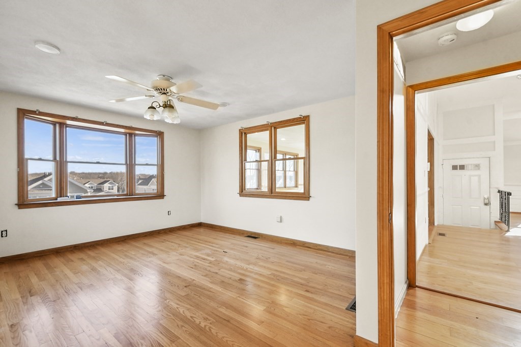 72 Cambridge Road, Unit 2 Woburn, MA 01801 - Photo 4 of 30 a view of an empty room with a window and wooden floor