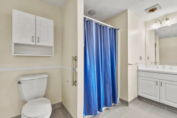 a bathroom with a toilet a sink and mirror