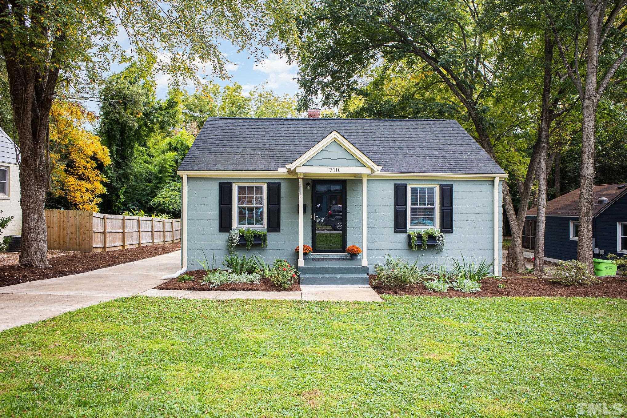 710 Tyler Road Raleigh, NC 27604 - Photo 1 of 27 a front view of a house with a garden and porch