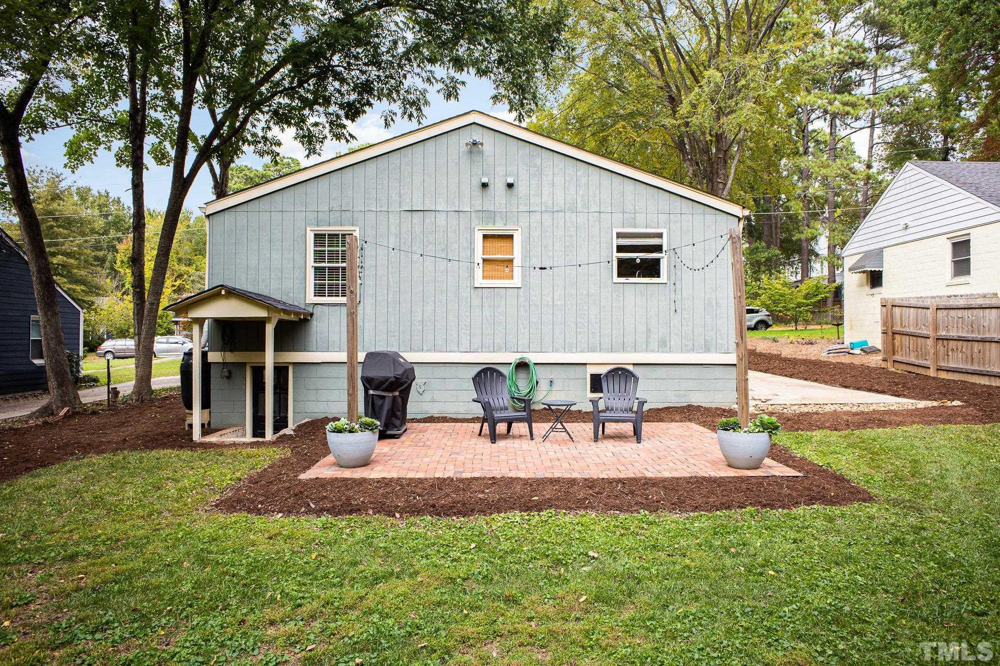 710 Tyler Road Raleigh, NC 27604 - Photo 23 of 27 a view of a house with a yard patio and fire pit