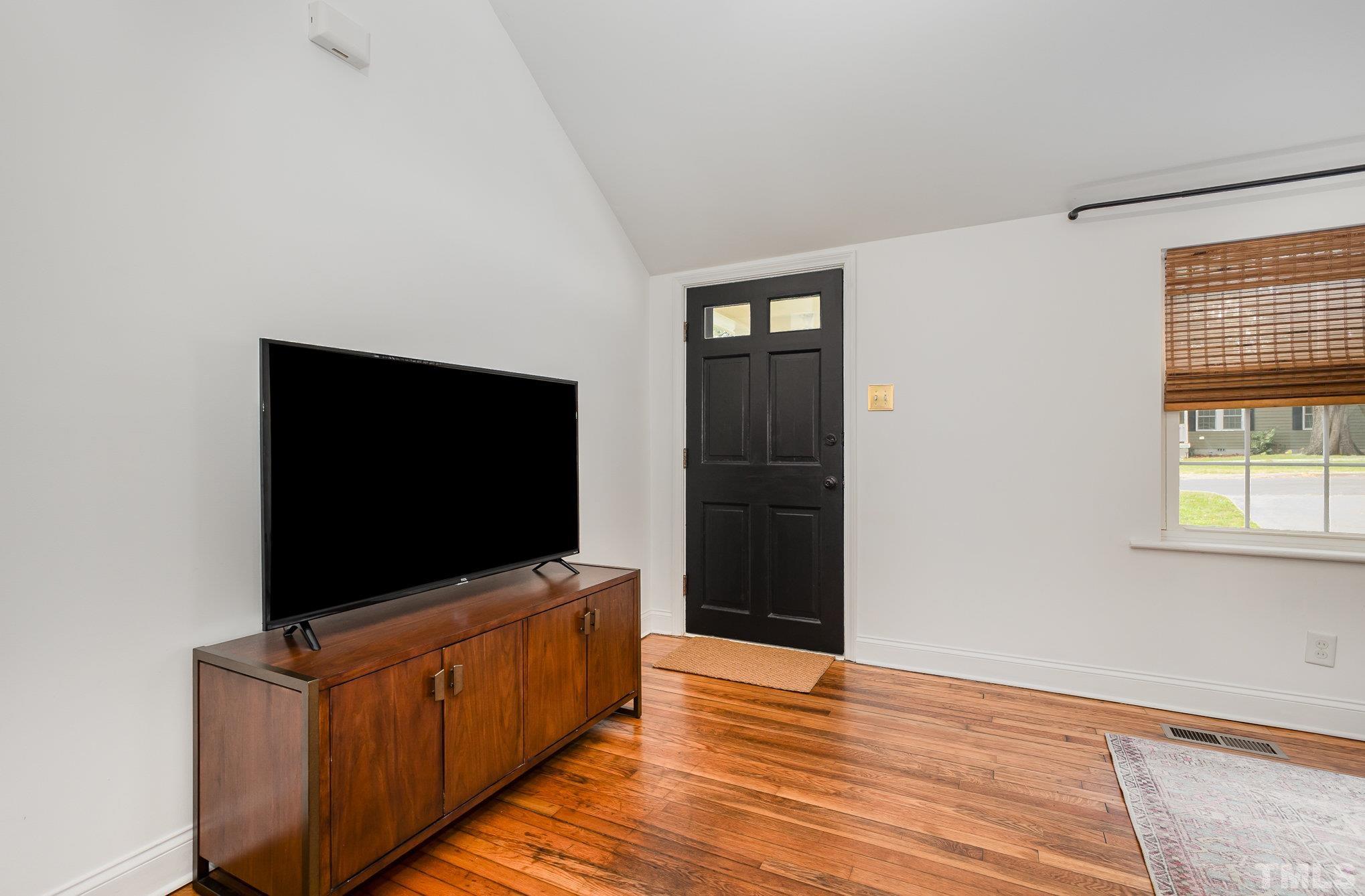 710 Tyler Road Raleigh, NC 27604 - Photo 7 of 27 a living room with furniture and flat screen tv
