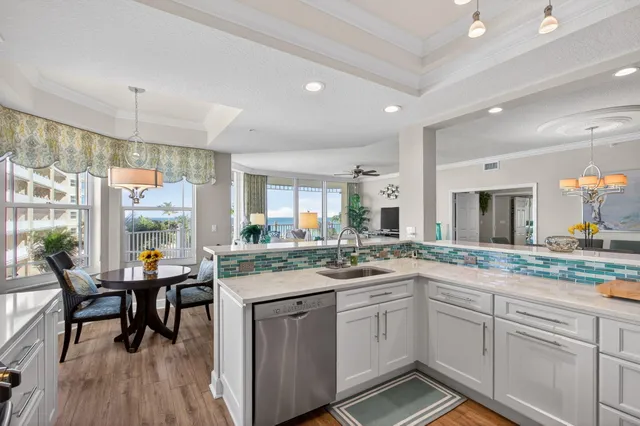 a kitchen with stainless steel appliances a refrigerator and wooden floor