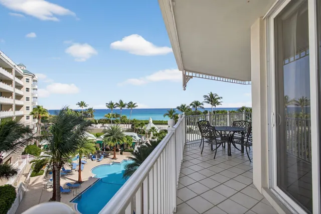 a living room with furniture a flat screen tv and a large window