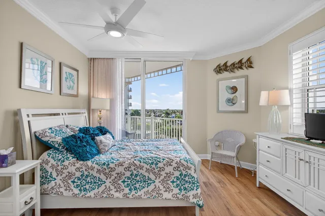 a view of a street with potted plants and brick walls