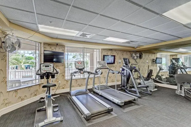 a living room with furniture and large windows