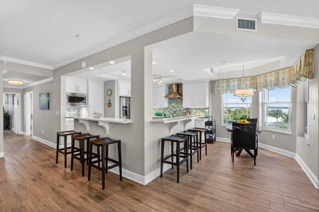 a kitchen with stainless steel appliances a table chairs and chandelier
